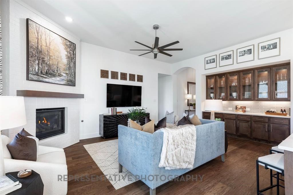 1609 Quartz Street Northlake, TX 76247 - Photo 6 of 40 a living room with furniture a flat screen tv and a fireplace