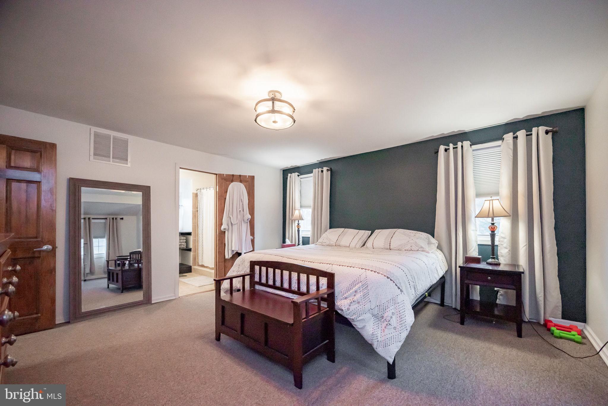 172 Morgantown Road Honey Brook, PA 19344 - Photo 11 of 29 a bedroom with a bed lamp and a large window