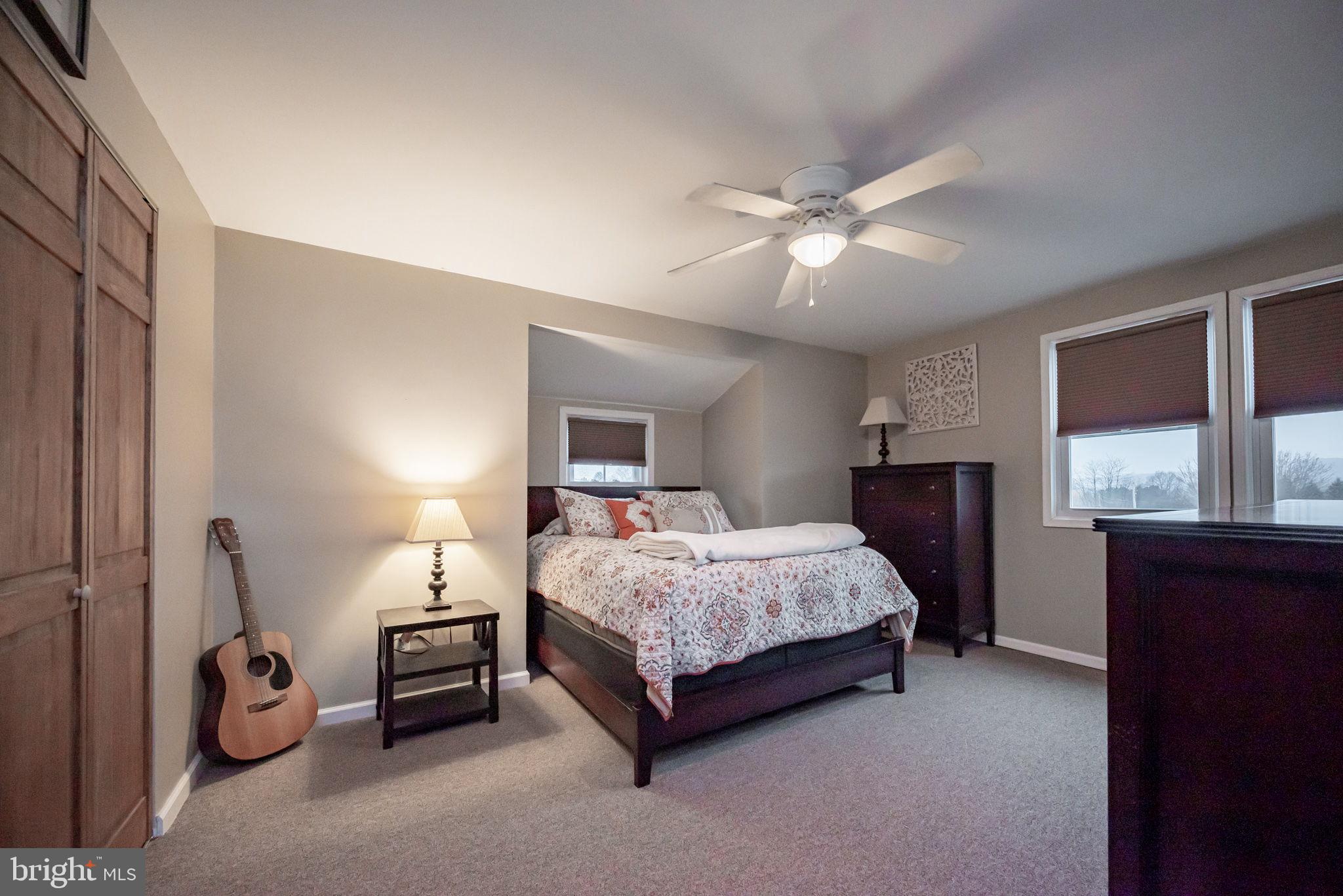 172 Morgantown Road Honey Brook, PA 19344 - Photo 14 of 29 a spacious bedroom with a bed and a chandelier