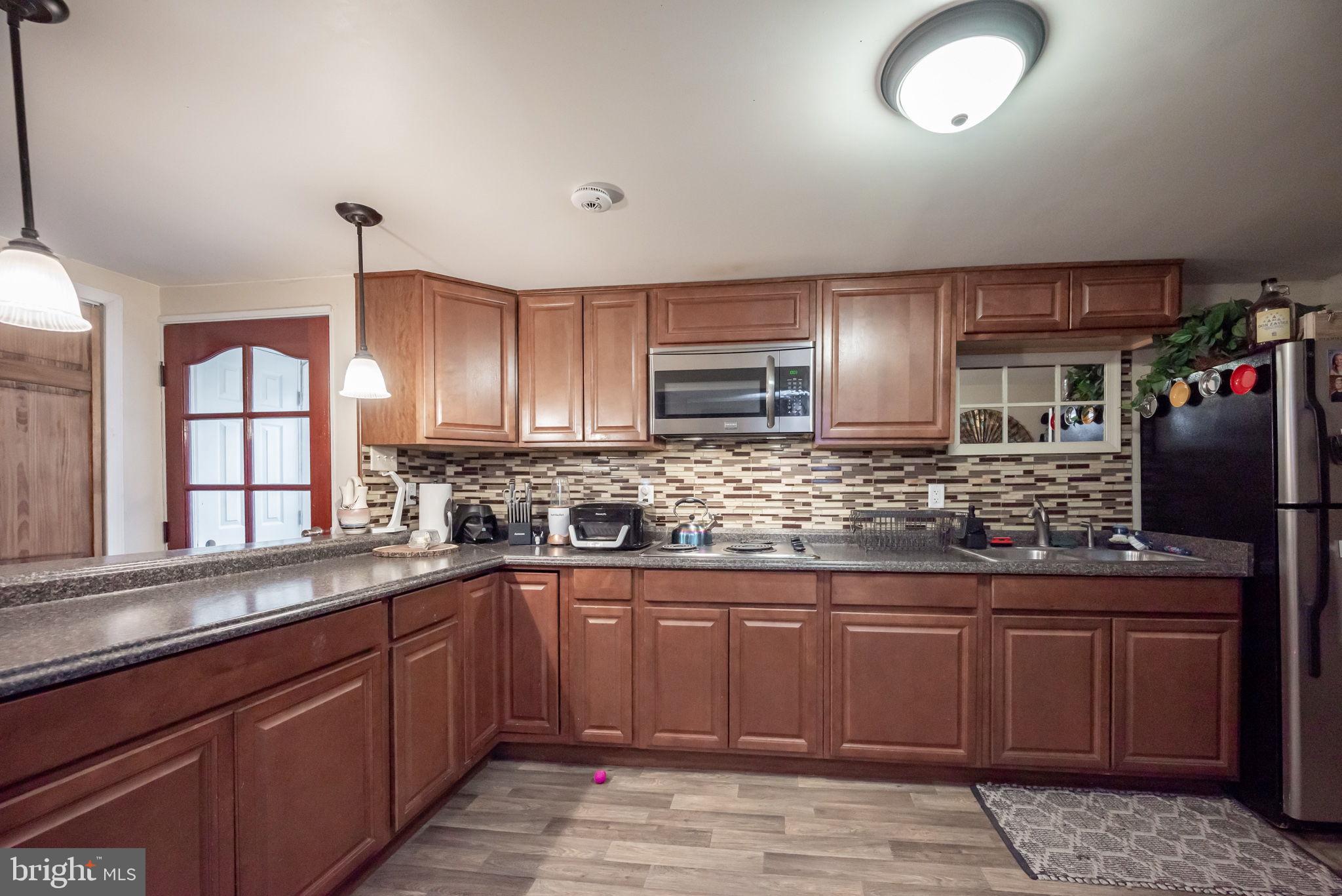 172 Morgantown Road Honey Brook, PA 19344 - Photo 19 of 29 a kitchen with stainless steel appliances granite countertop a sink stove and cabinets