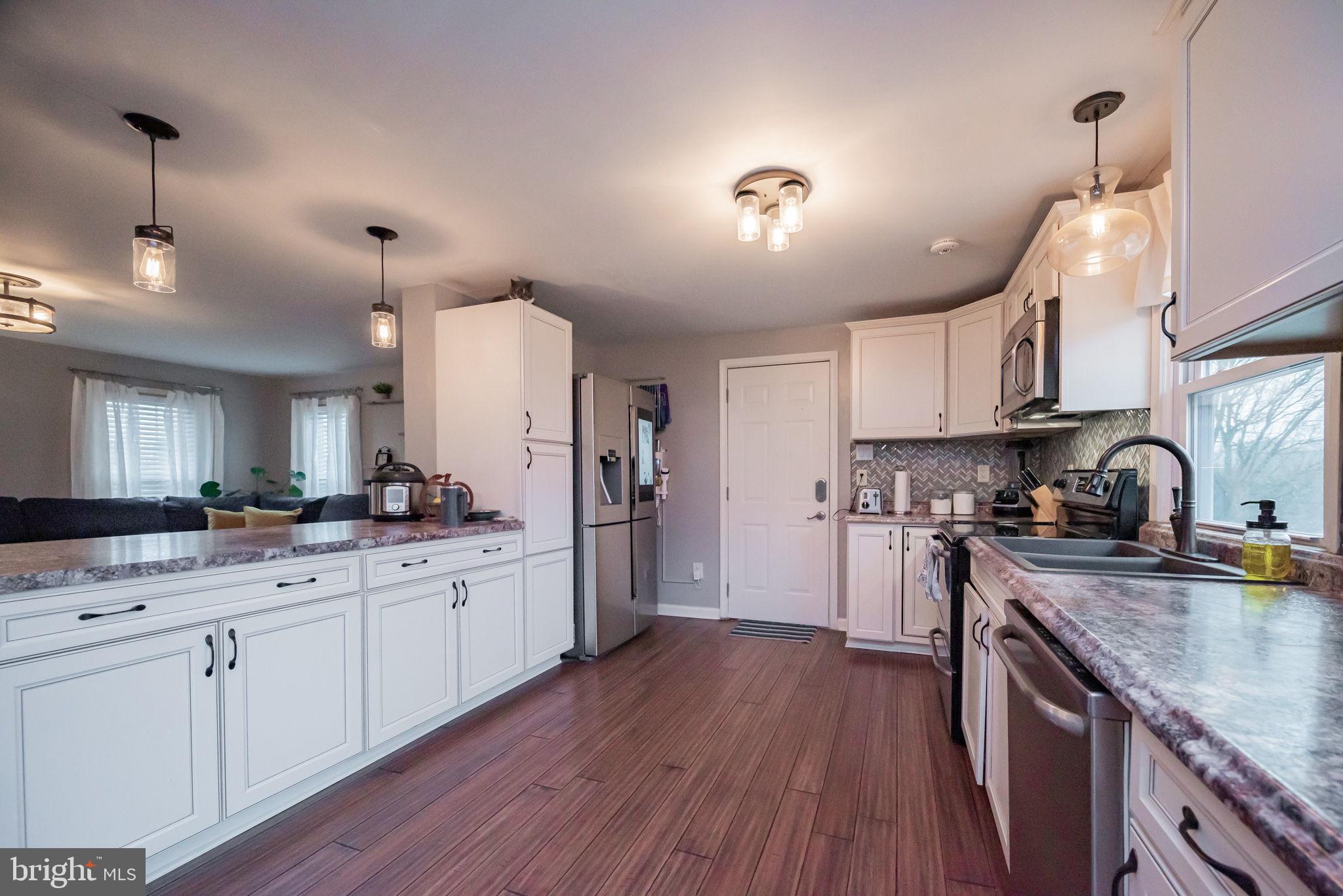 172 Morgantown Road Honey Brook, PA 19344 - Photo 5 of 29 a kitchen with white cabinets and stainless steel appliances