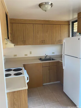 a kitchen with a refrigerator and a sink