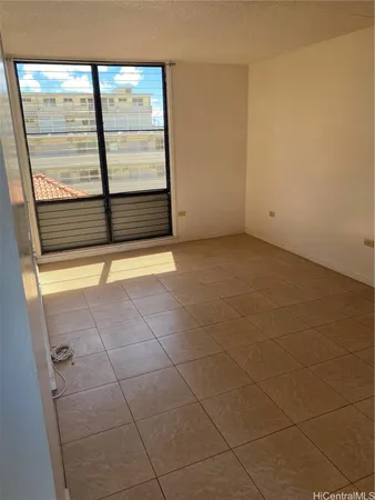 a view of a room with an empty space and a window