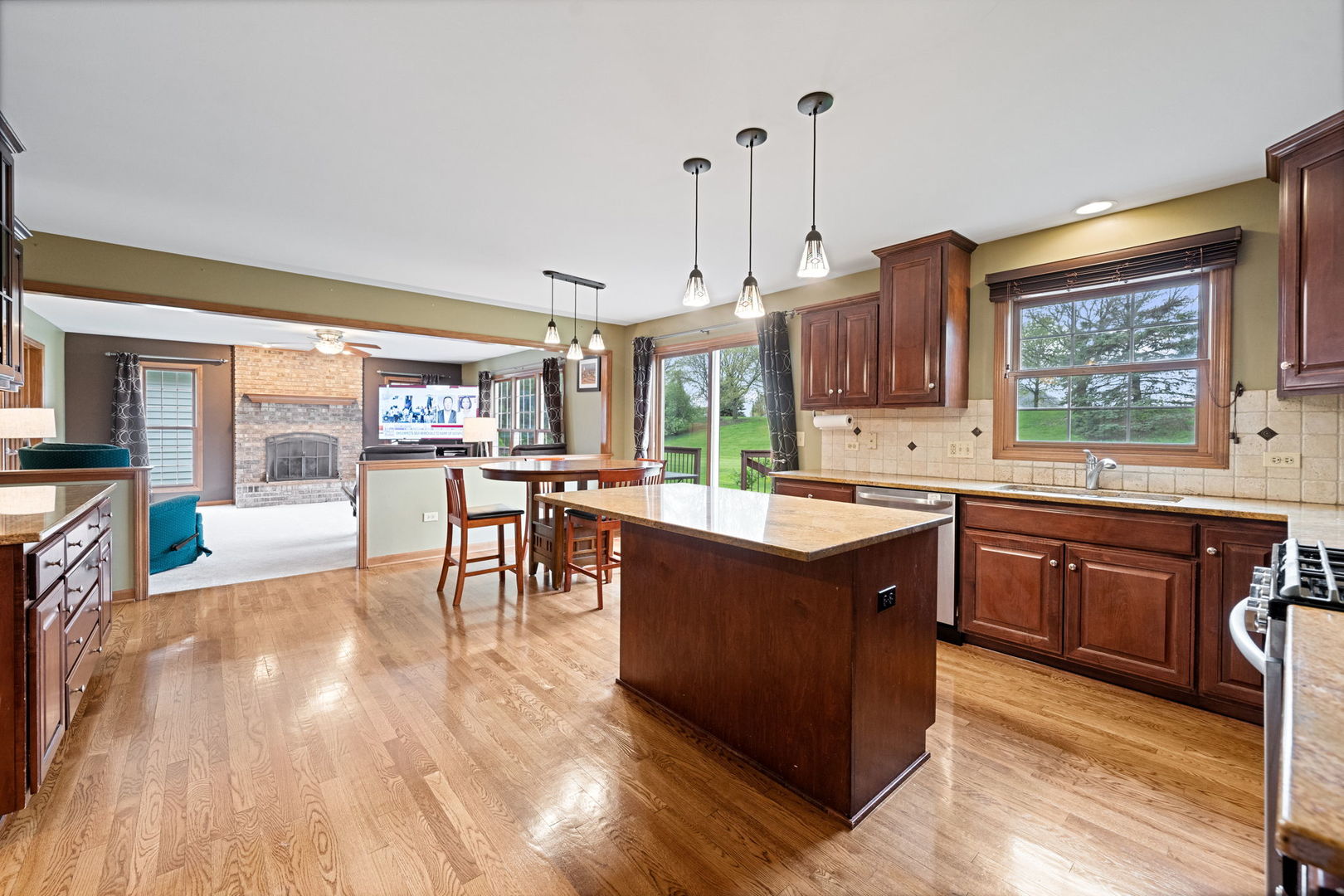 4123 Easy Circle Naperville, IL 60564 - Photo 13 of 45 a large kitchen with stainless steel appliances granite countertop wooden floors wooden cabinets a window and a sink