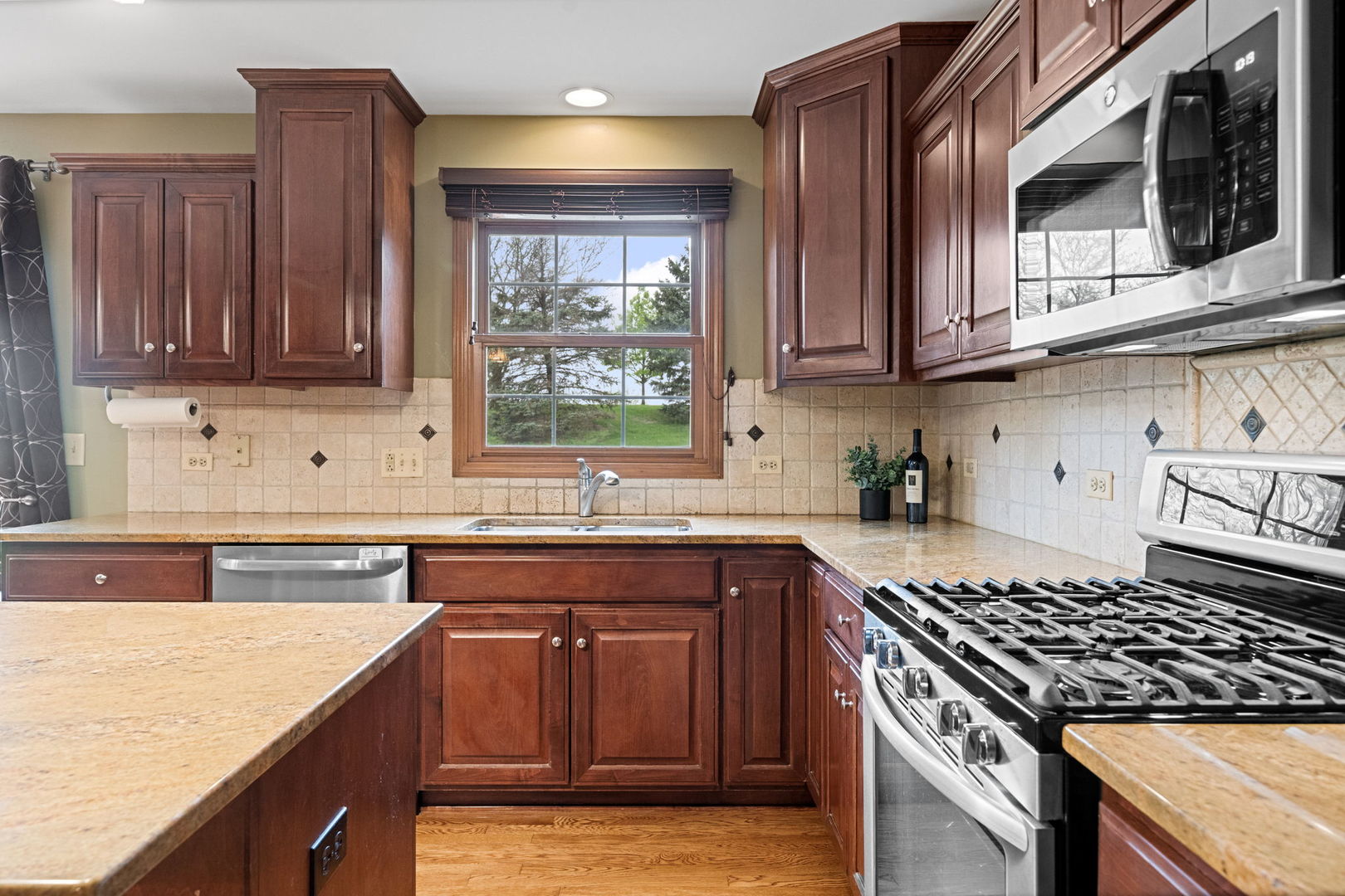 4123 Easy Circle Naperville, IL 60564 - Photo 14 of 45 a kitchen with stainless steel appliances granite countertop a sink stove and cabinets