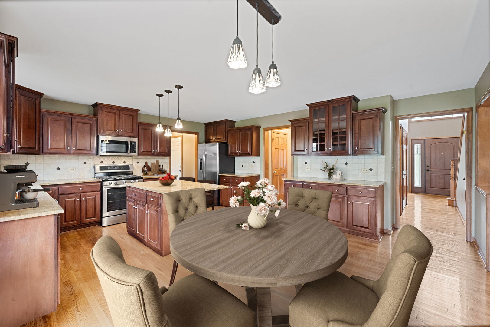 4123 Easy Circle Naperville, IL 60564 - Photo 16 of 45 a kitchen with stainless steel appliances kitchen island granite countertop a table chairs and a refrigerator