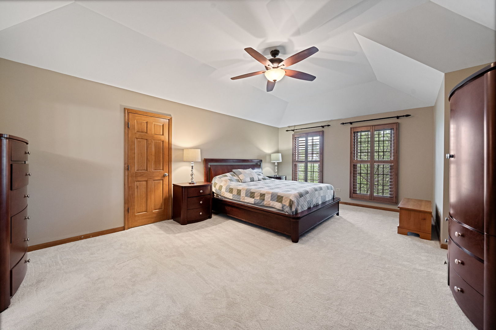 4123 Easy Circle Naperville, IL 60564 - Photo 22 of 45 a spacious bedroom with a bed a chandelier and a flat screen television