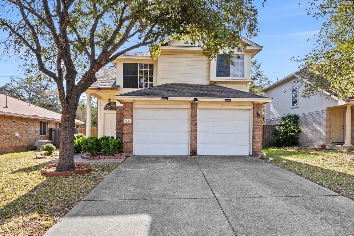 a front view of a house with a yard and garage