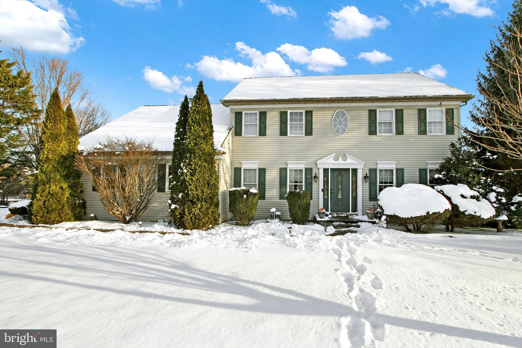 a view of a house with snow on the background