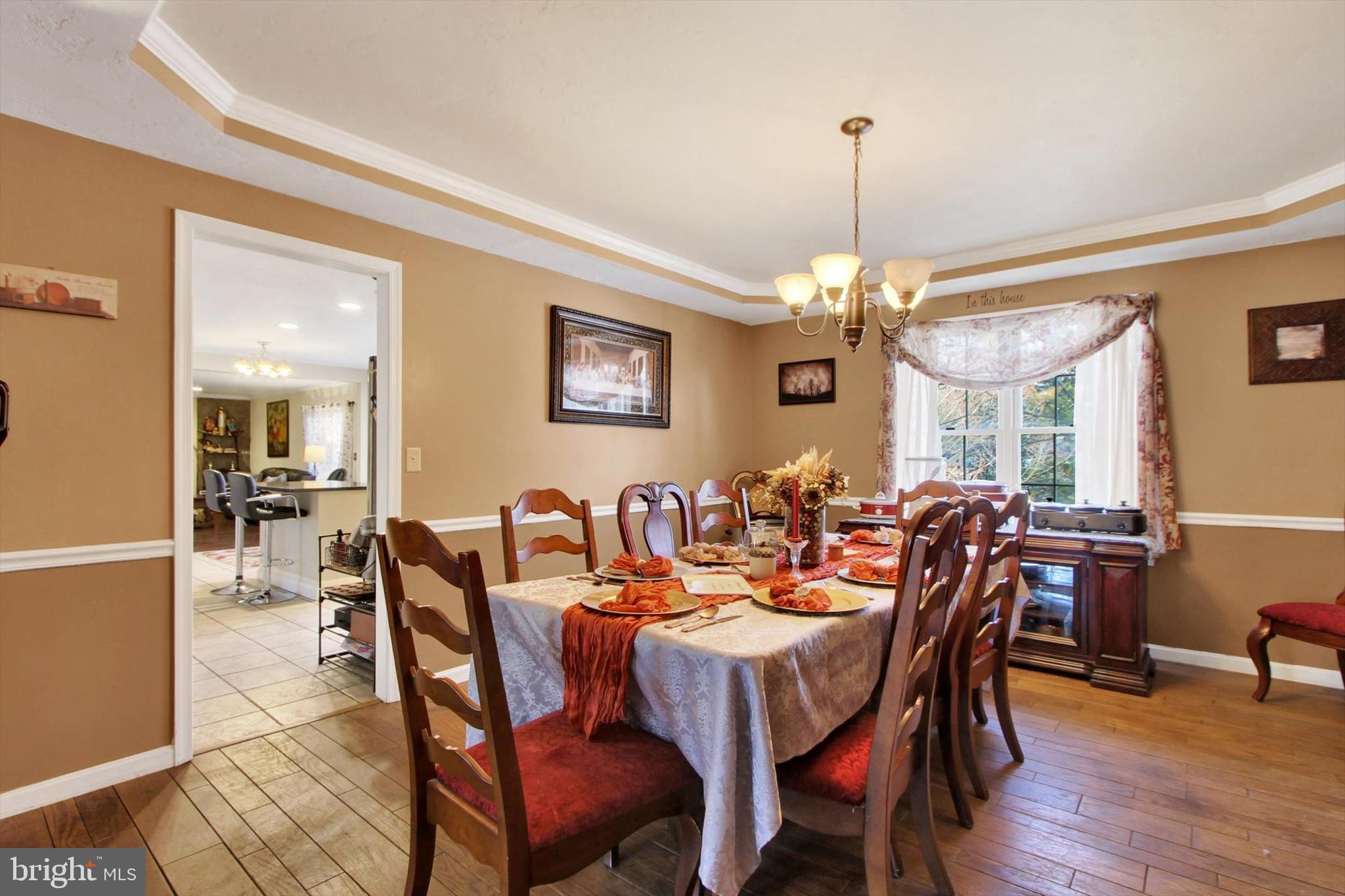 1122 Laurel Drive York, PA 17404 - Photo 11 of 38 a view of a dining room and livingroom furniture a chandelier and wooden floor