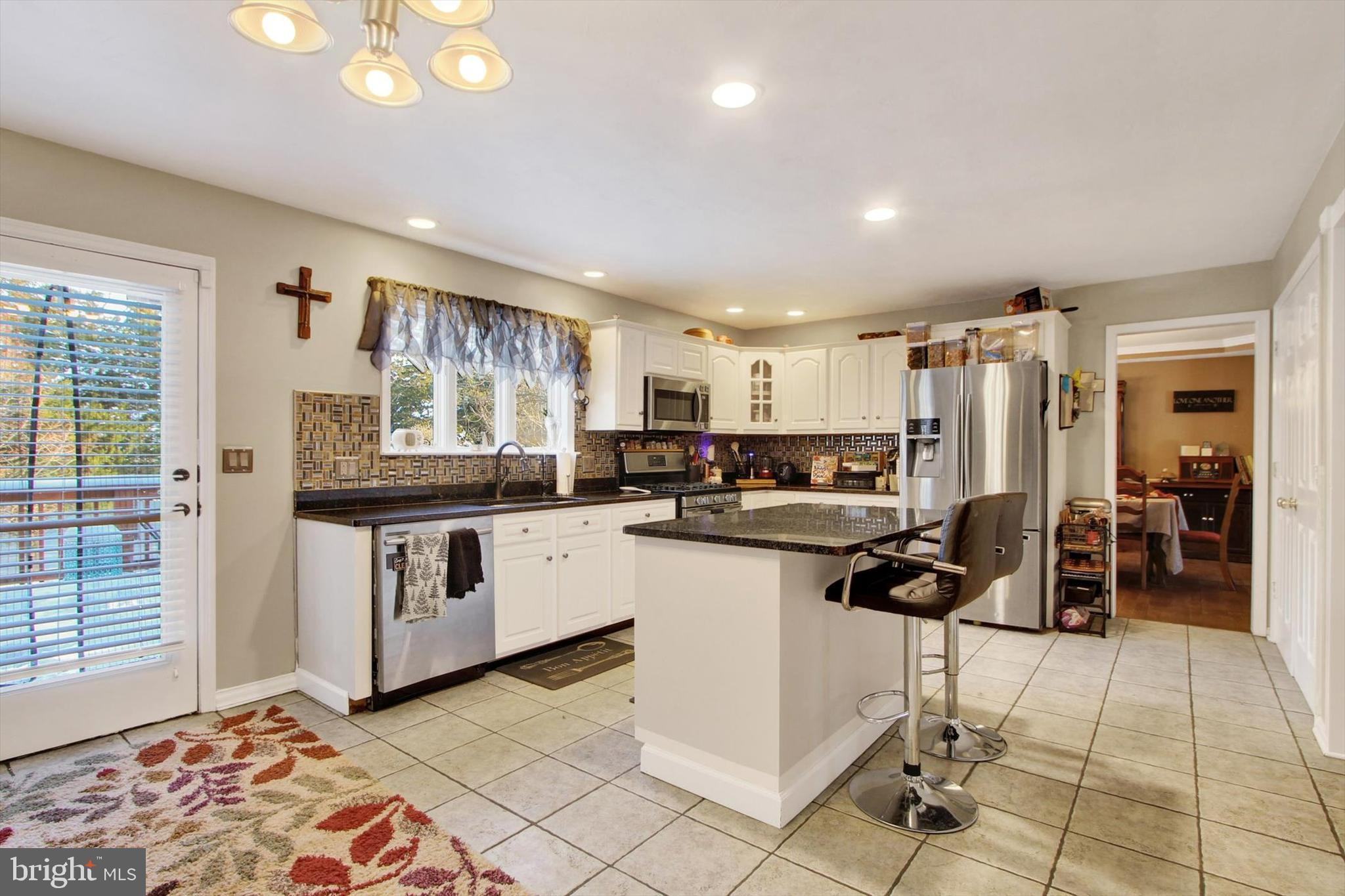 1122 Laurel Drive York, PA 17404 - Photo 12 of 38 a kitchen with stainless steel appliances kitchen island granite countertop a stove and cabinets