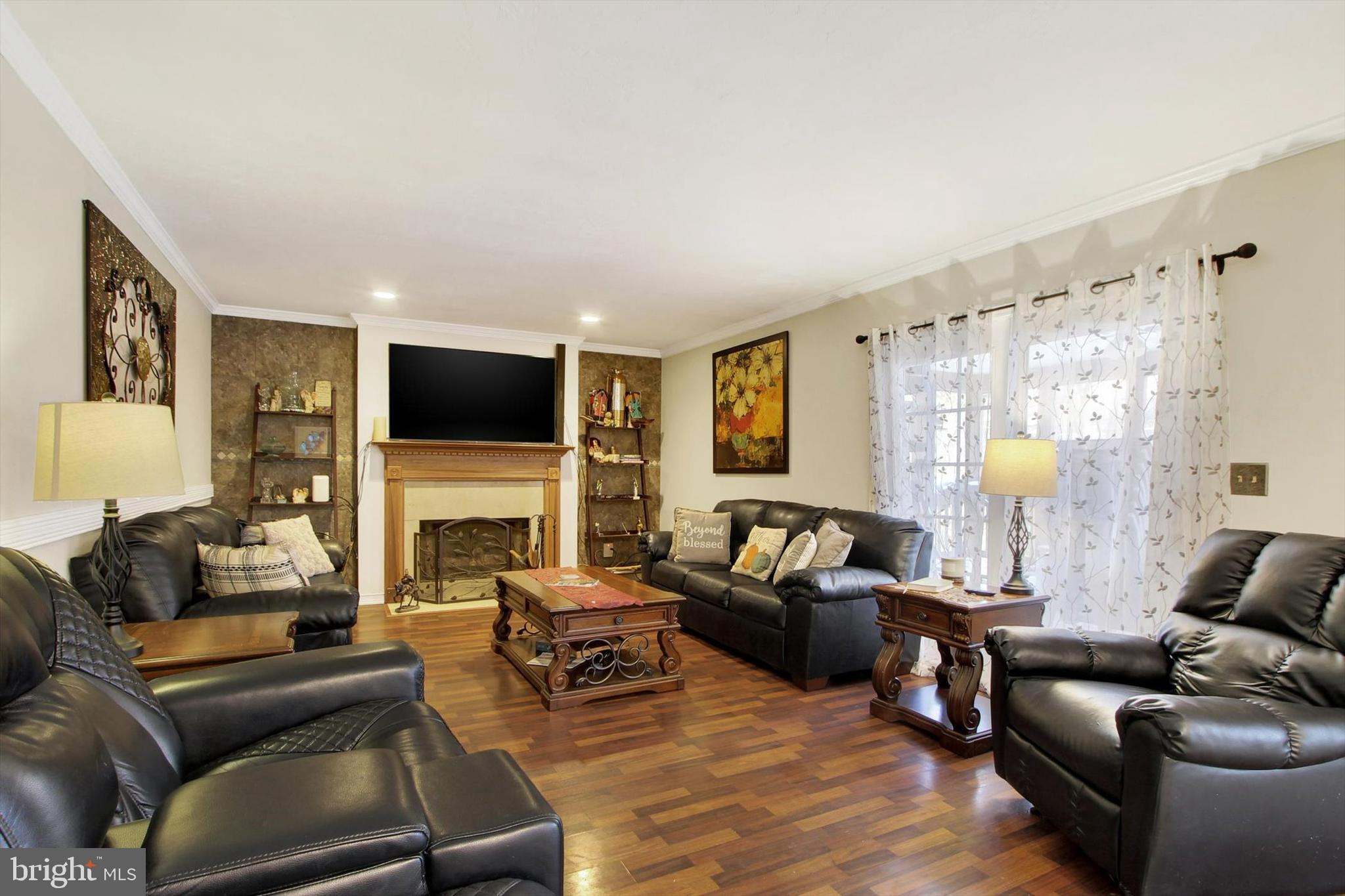 1122 Laurel Drive York, PA 17404 - Photo 18 of 38 a living room with furniture a fireplace and a flat screen tv