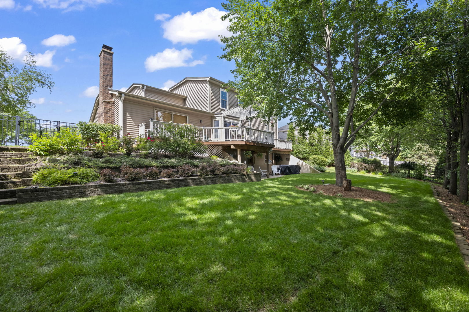 1565 Freeman Road Hoffman Estates, IL 60192 - Photo 7 of 46 a front view of a house with a yard table and chairs