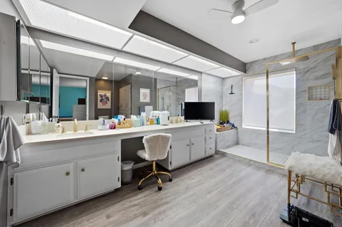 a view of kitchen with stainless steel appliances kitchen island granite countertop a sink and cabinets