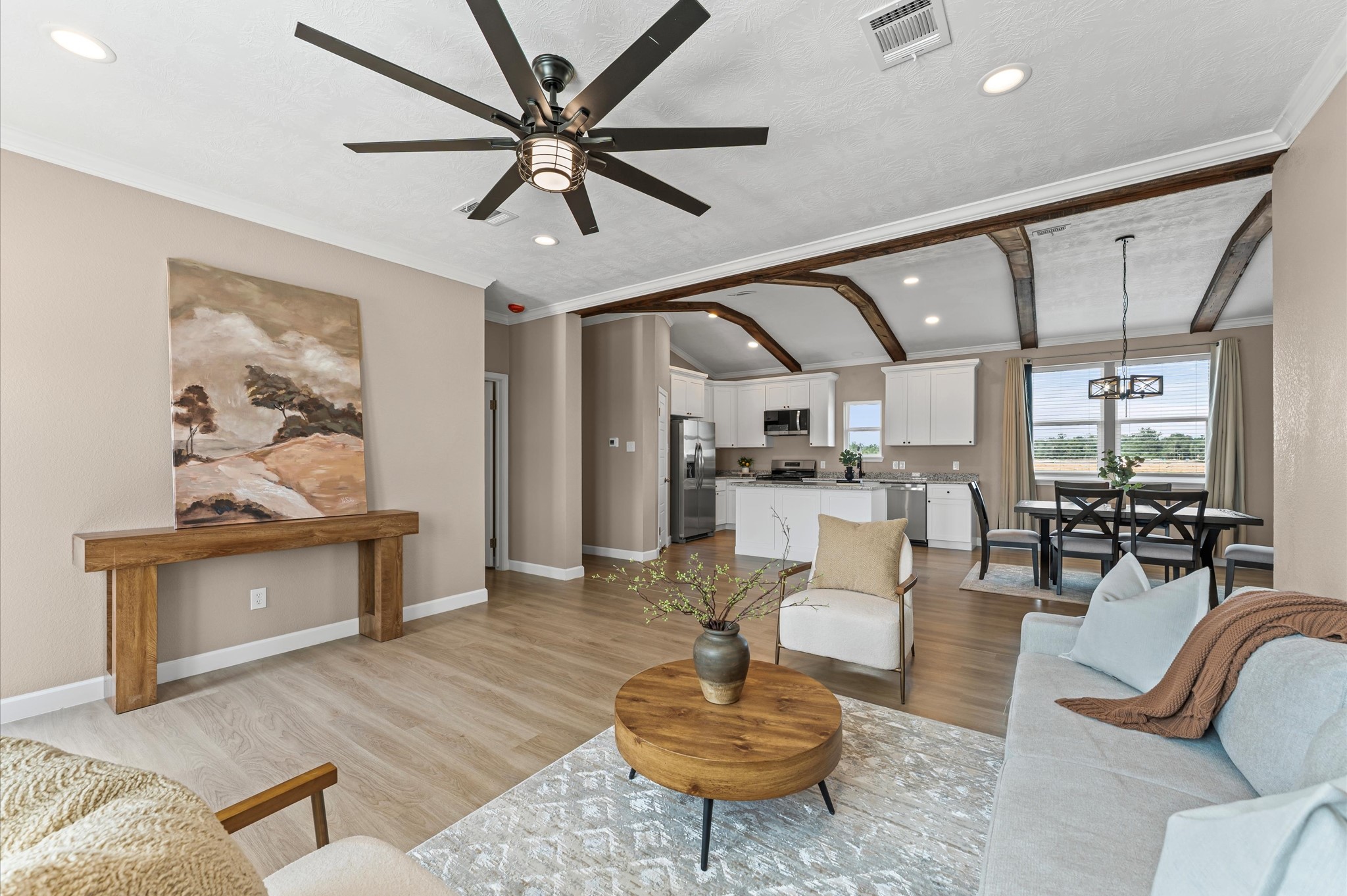 a living room with furniture and kitchen view