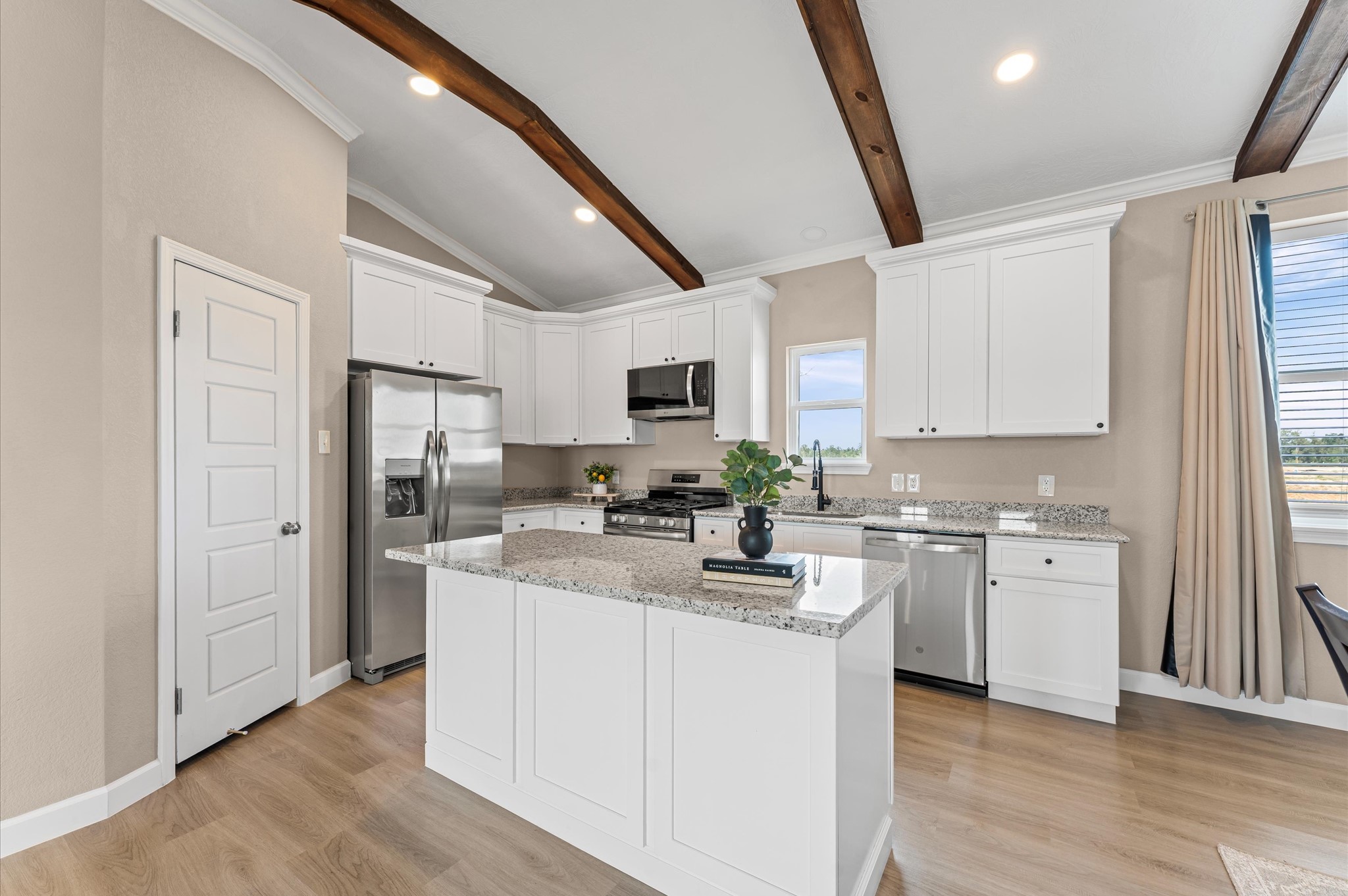 1207 Peter Pne Street Huffman, TX 77336 - Photo 11 of 30 a kitchen with cabinets a sink a window and stainless steel appliances