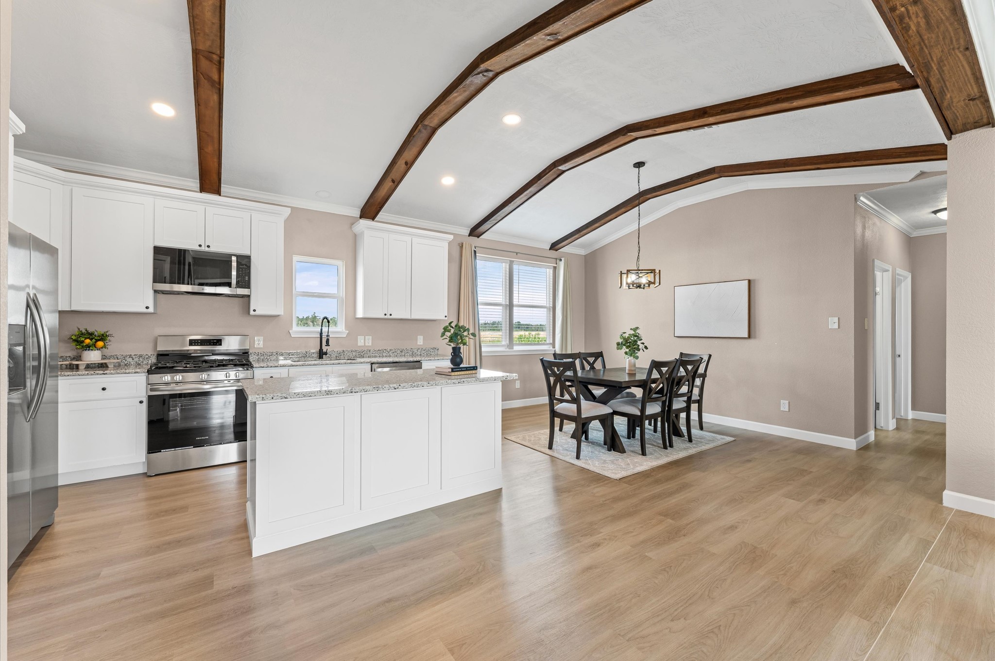 1207 Peter Pne Street Huffman, TX 77336 - Photo 10 of 30 a kitchen with stainless steel appliances granite countertop a stove top oven a sink a dining table and chairs with wooden floor