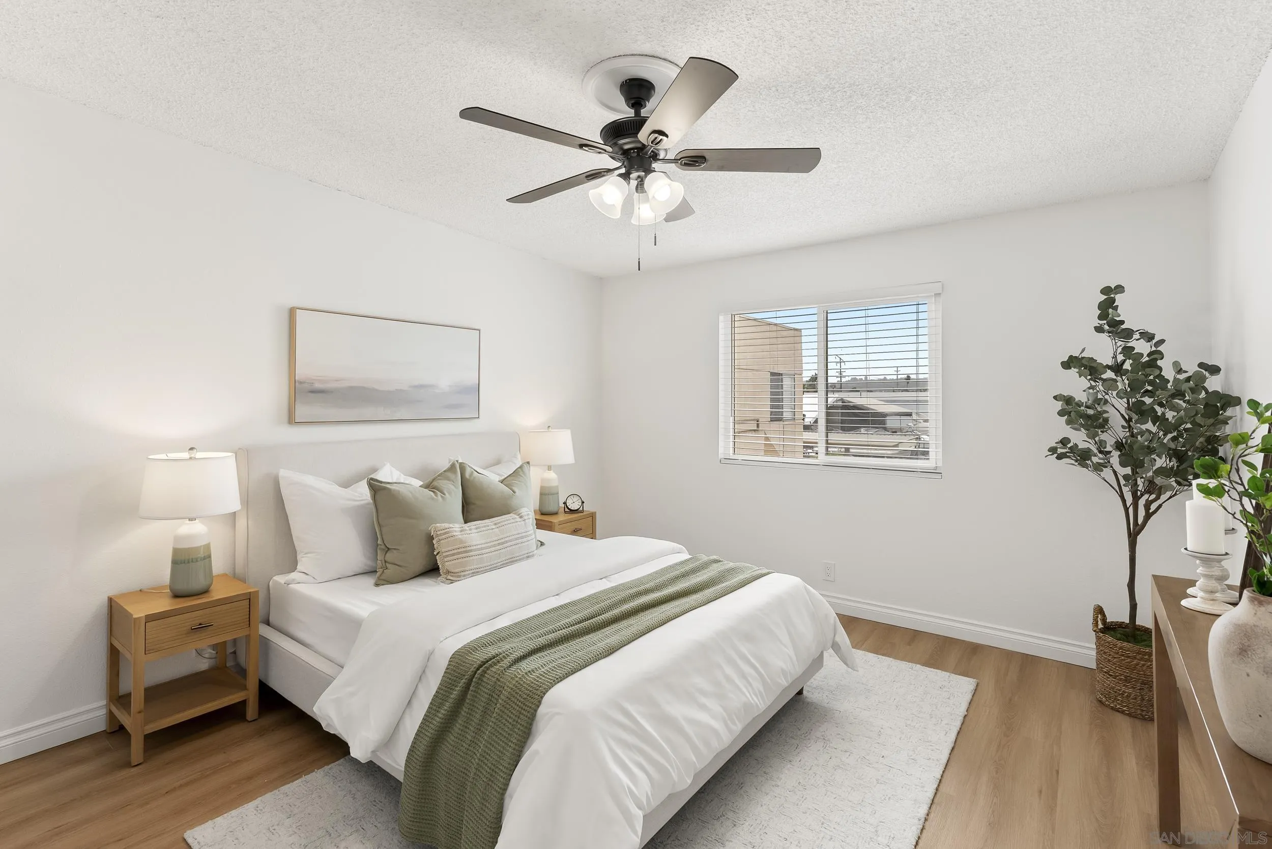 830 Broadway, Unit 15 El Cajon, CA 92021 - Photo 14 of 21 a bedroom with a bed and a chandelier