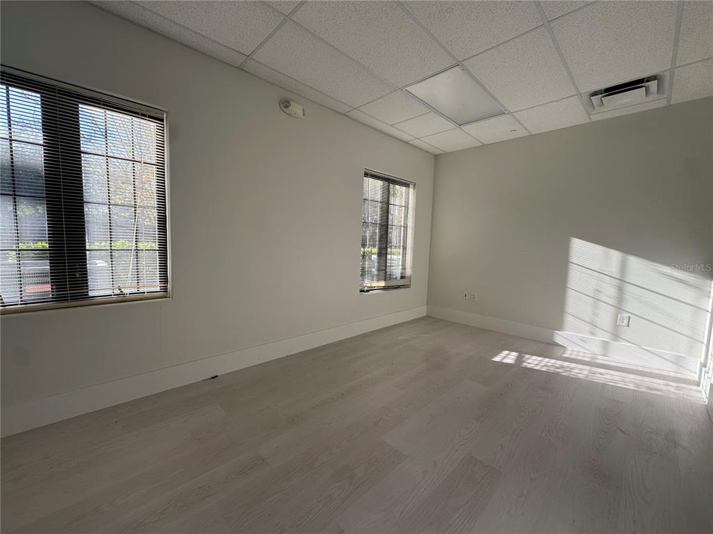 6052 Turkey Lake Road, Unit 118 Orlando, FL 32819 - Photo 7 of 11 an empty room with windows