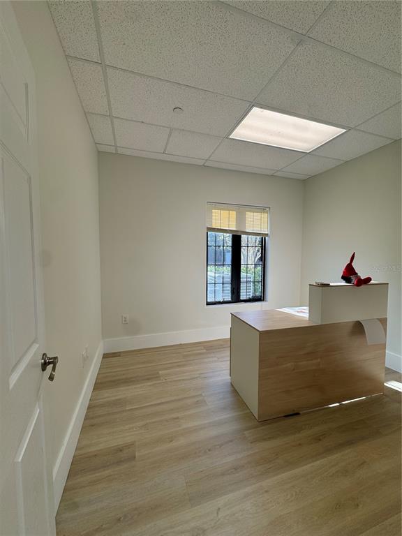 6052 Turkey Lake Road, Unit 118 Orlando, FL 32819 - Photo 8 of 11 wooden floor in an empty room with a window