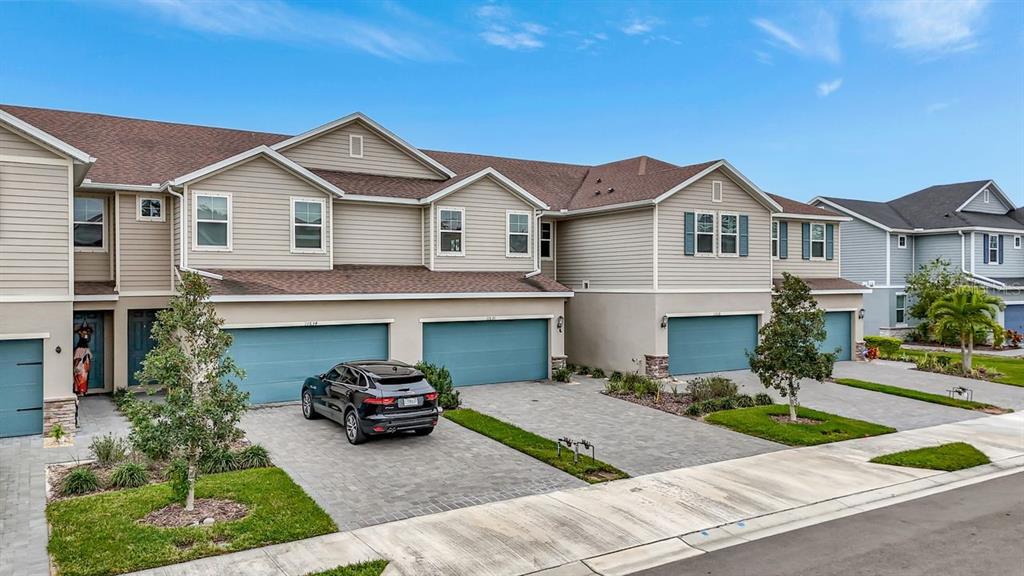 a front view of a house with a yard and garage