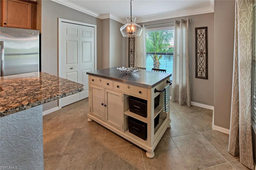 9513 Avellino Way, Unit 2024 Naples, FL 34113 - Photo 11 of 33 a kitchen with stainless steel appliances granite countertop a stove and a sink