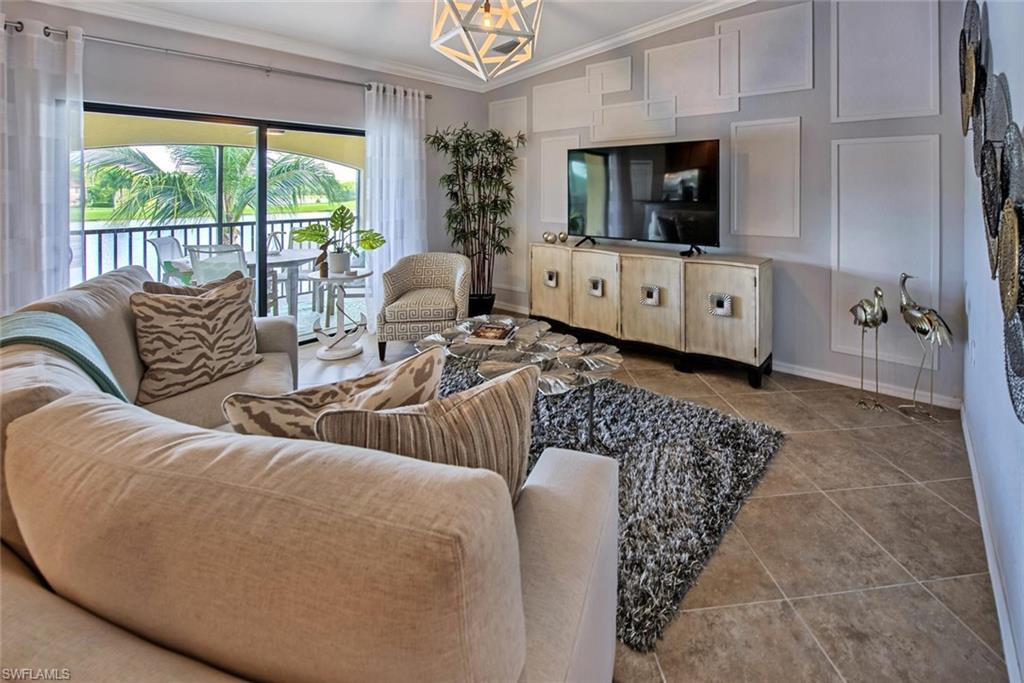 9513 Avellino Way, Unit 2024 Naples, FL 34113 - Photo 13 of 33 a living room with furniture and a flat screen tv