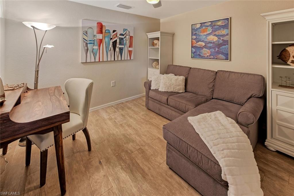 9513 Avellino Way, Unit 2024 Naples, FL 34113 - Photo 14 of 33 a living room with furniture and a wooden floor