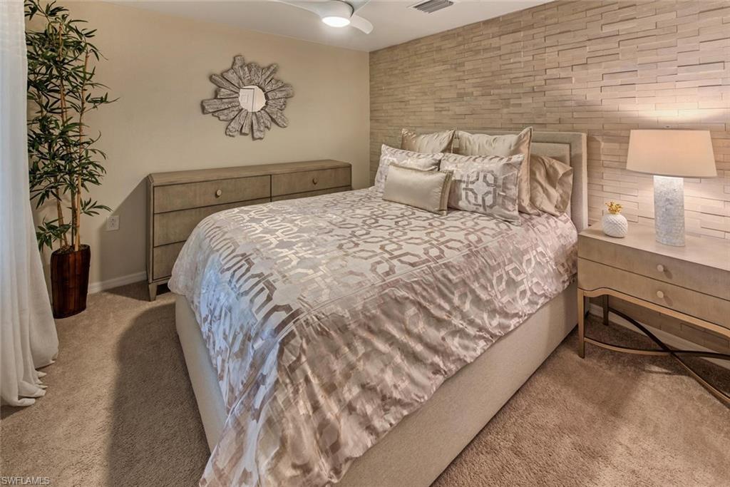 9513 Avellino Way, Unit 2024 Naples, FL 34113 - Photo 18 of 33 a bedroom with a bed and a painting on the wall