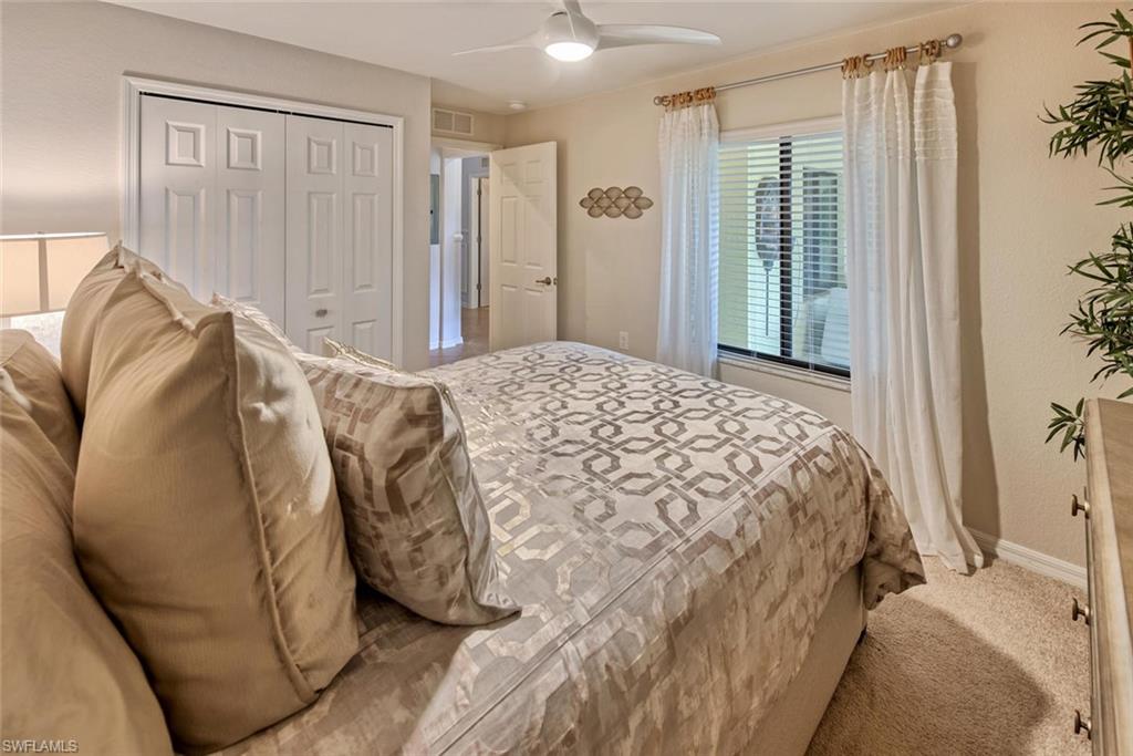 9513 Avellino Way, Unit 2024 Naples, FL 34113 - Photo 19 of 33 a bedroom with a bed and a window