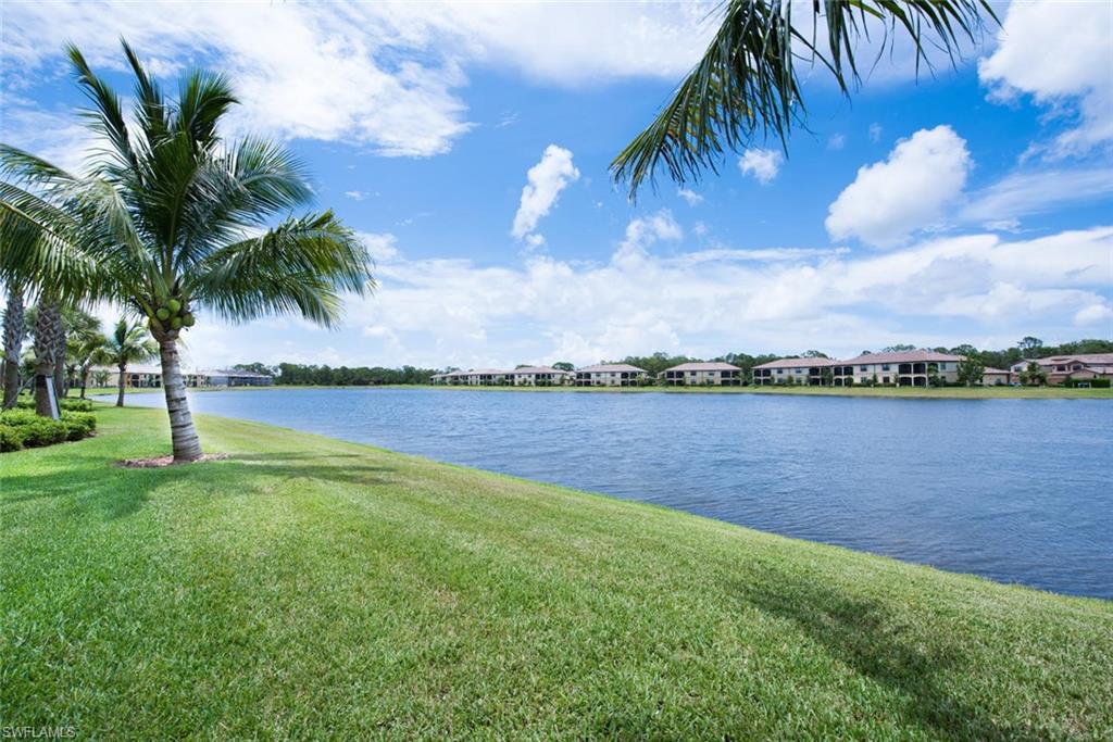 9513 Avellino Way, Unit 2024 Naples, FL 34113 - Photo 23 of 33 a view of a lake and palm trees