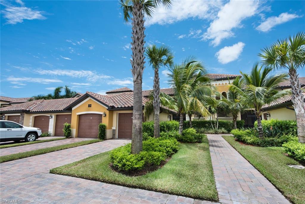 9513 Avellino Way, Unit 2024 Naples, FL 34113 - Photo 4 of 33 a front view of a house with a garden