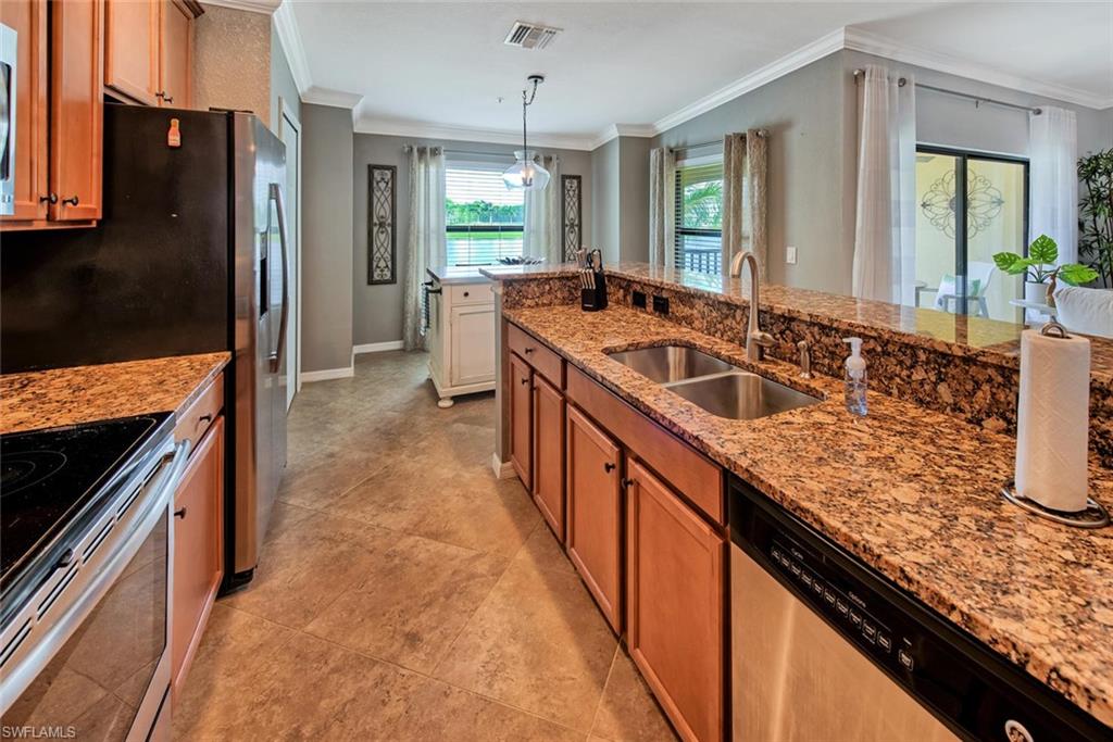 9513 Avellino Way, Unit 2024 Naples, FL 34113 - Photo 10 of 33 a large kitchen with granite countertop a sink and a stove