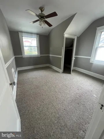 an empty room with windows and entrance