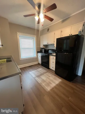 a kitchen with granite countertop a refrigerator stove and microwave