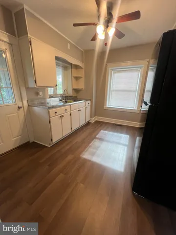a view of a kitchen with a sink dishwasher and a fireplace
