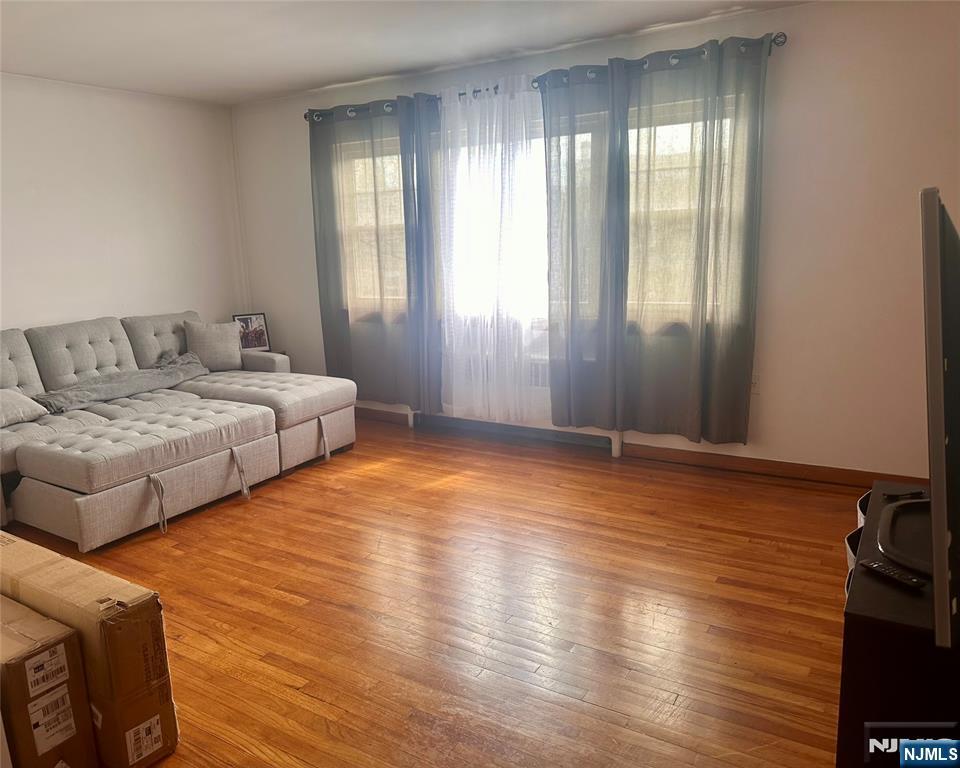 237 Riverview Place, Unit 2 Cliffside Park, NJ 07010 - Photo 2 of 11 a bedroom with natural light and wooden floor