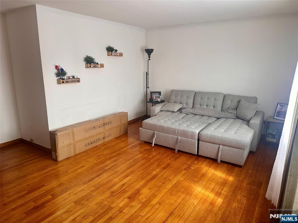 237 Riverview Place, Unit 2 Cliffside Park, NJ 07010 - Photo 3 of 11 a living room with furniture and a wooden floor