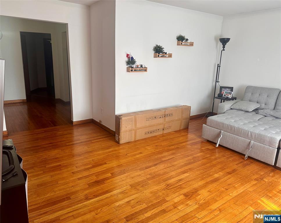 237 Riverview Place, Unit 2 Cliffside Park, NJ 07010 - Photo 4 of 11 a living room with furniture and a wooden floor