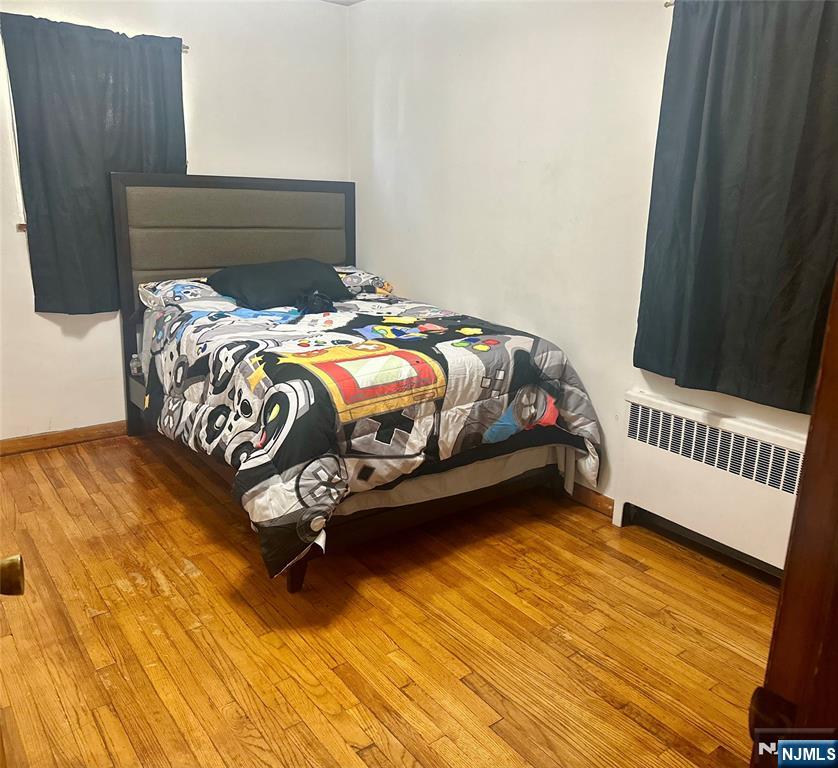 237 Riverview Place, Unit 2 Cliffside Park, NJ 07010 - Photo 7 of 11 a bed sitting in a bedroom next to a small yard