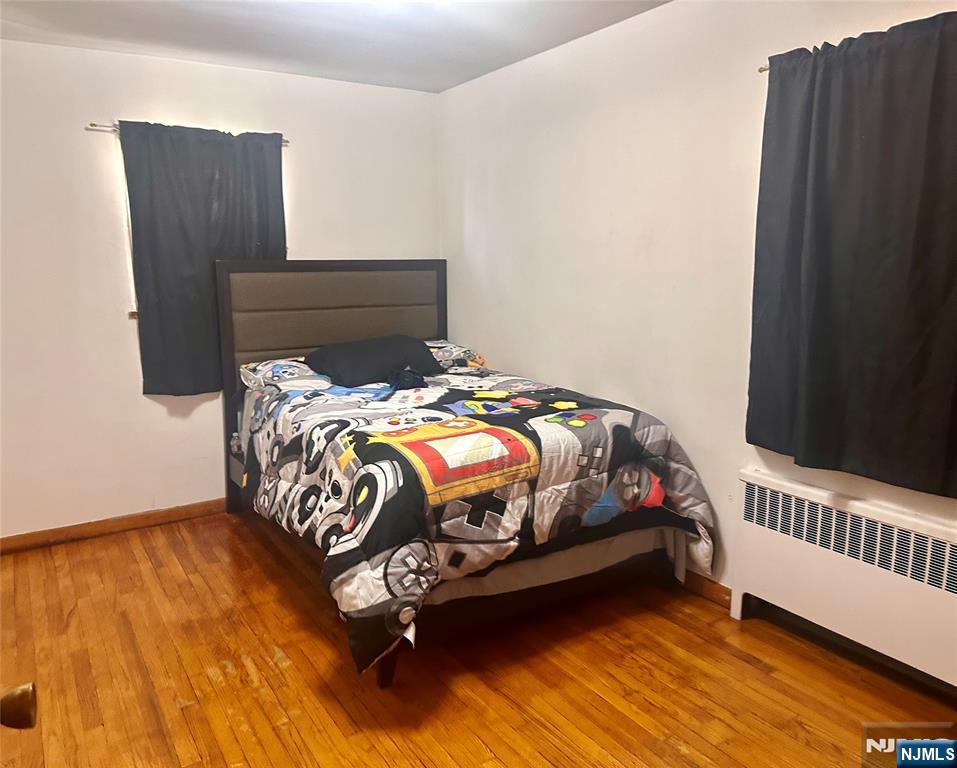 237 Riverview Place, Unit 2 Cliffside Park, NJ 07010 - Photo 8 of 11 a bedroom with a bed and wooden floor