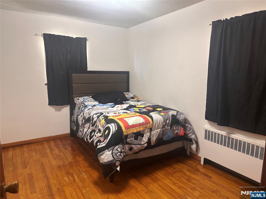 237 Riverview Place, Unit 2 Cliffside Park, NJ 07010 - Photo 9 of 11 a bed sitting in a bedroom next to a wooden floor