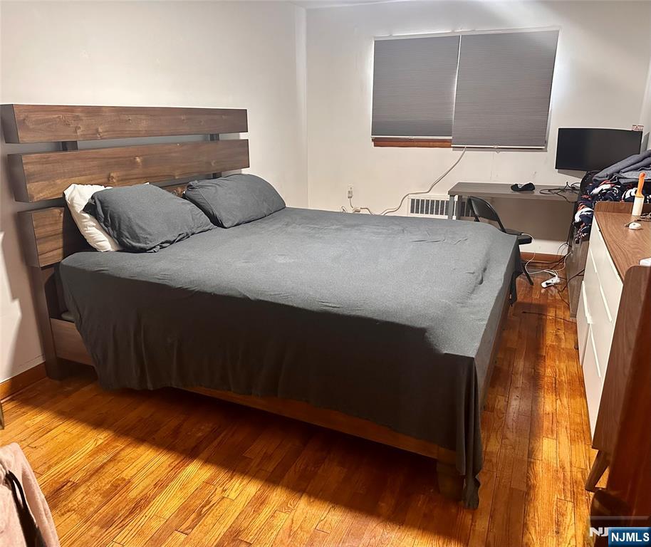237 Riverview Place, Unit 2 Cliffside Park, NJ 07010 - Photo 10 of 11 a bedroom with a bed and a flat tv screen on dresser