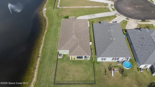 an aerial view of a house with a swimming pool