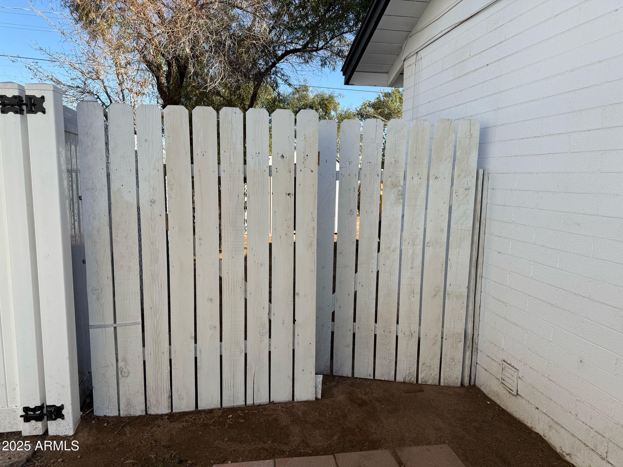 5000 West Osborn Road Phoenix, AZ 85031 - Photo 20 of 23 a view of a backyard with wooden fence