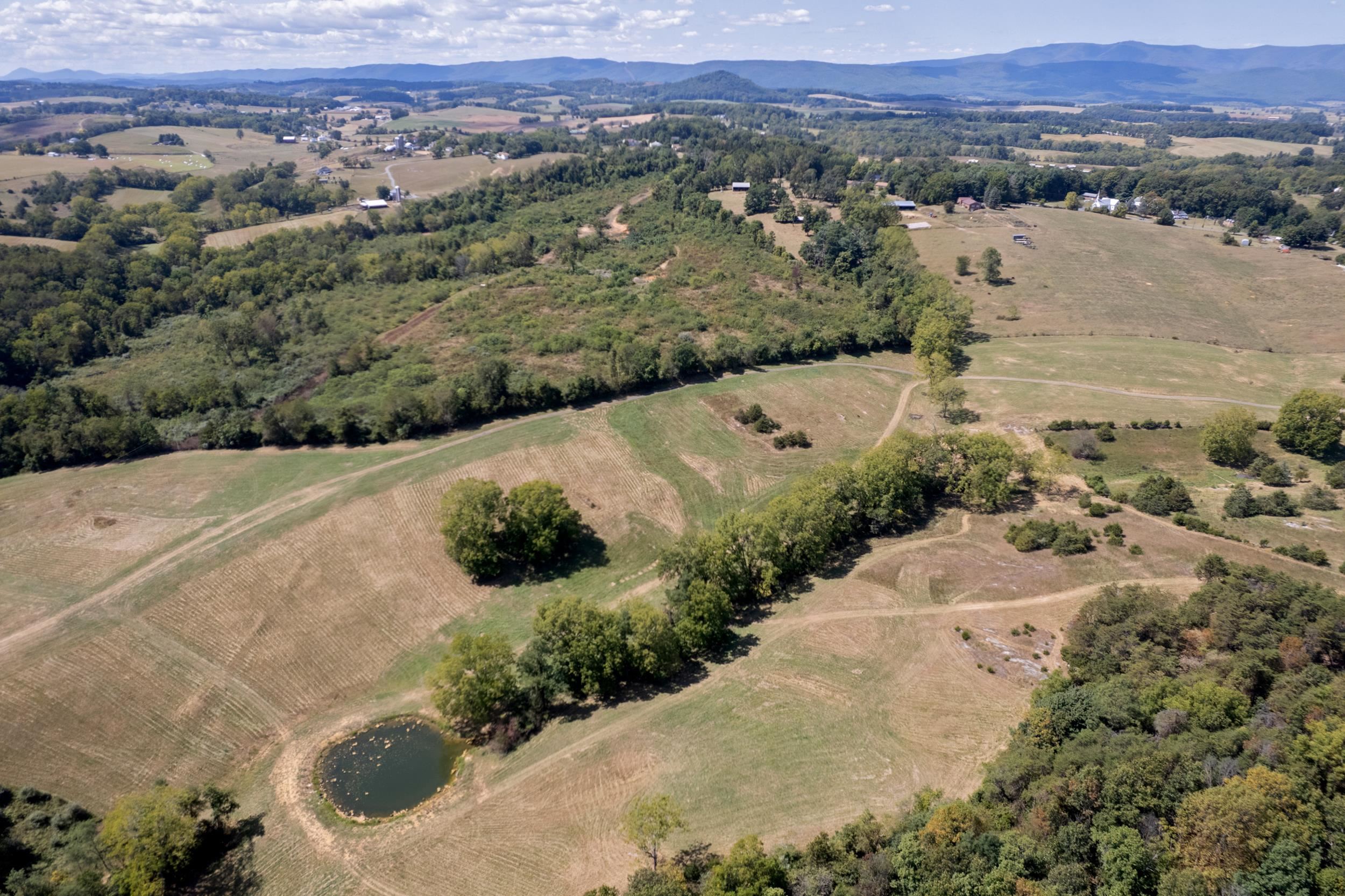 an aerial view of mountain with residential space and mountain view in back