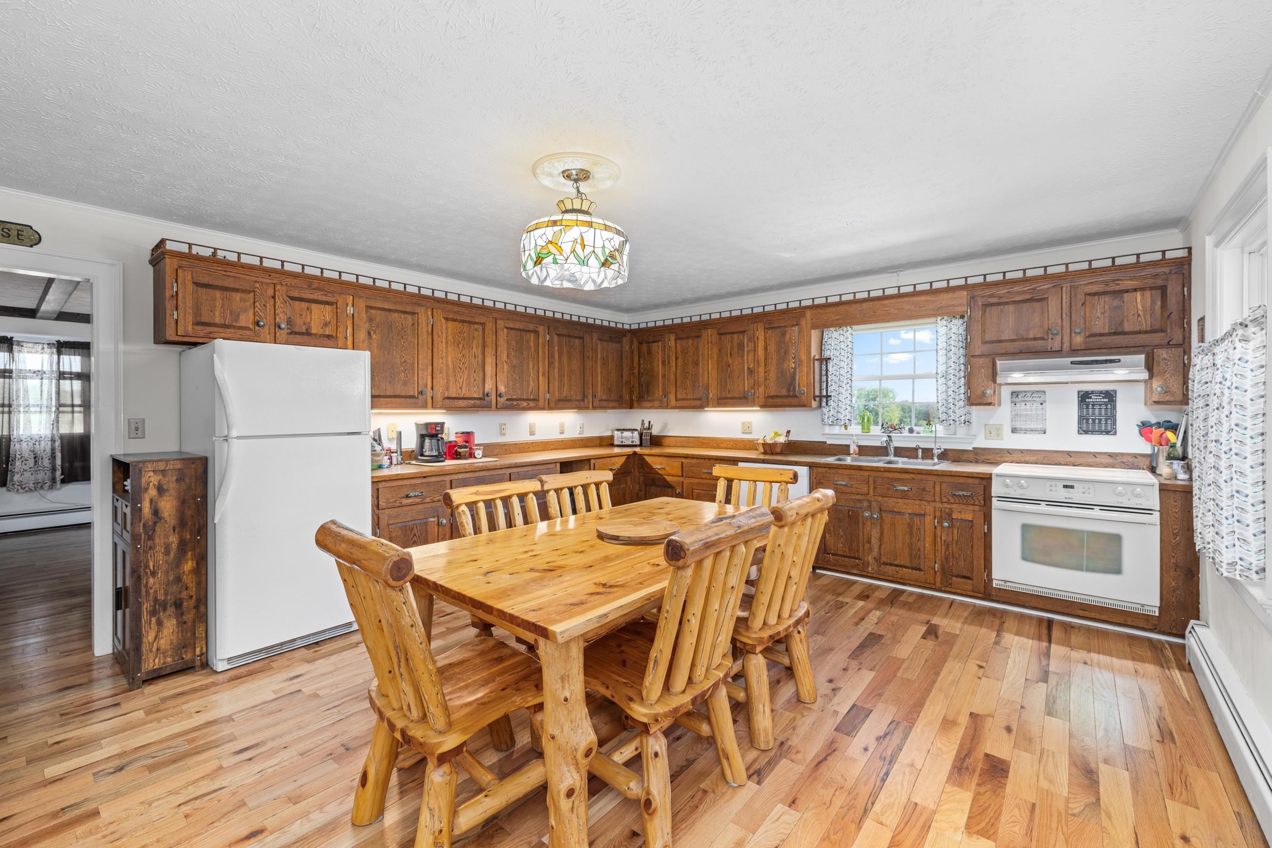 1370 Middlebrook Road Staunton, VA 24401 - Photo 25 of 73 a dining room with a table chairs and a kitchen view