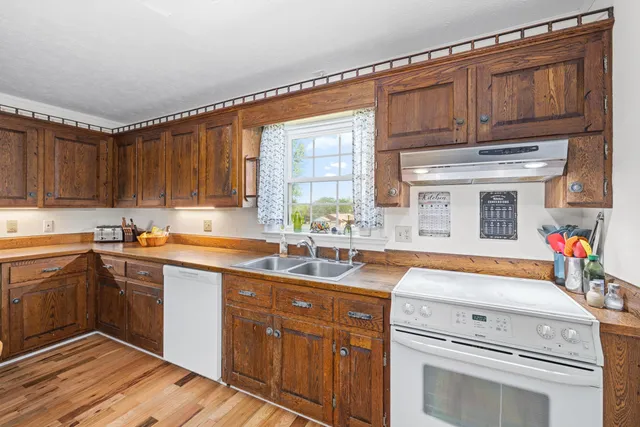 a kitchen with stainless steel appliances granite countertop a refrigerator and a stove top oven