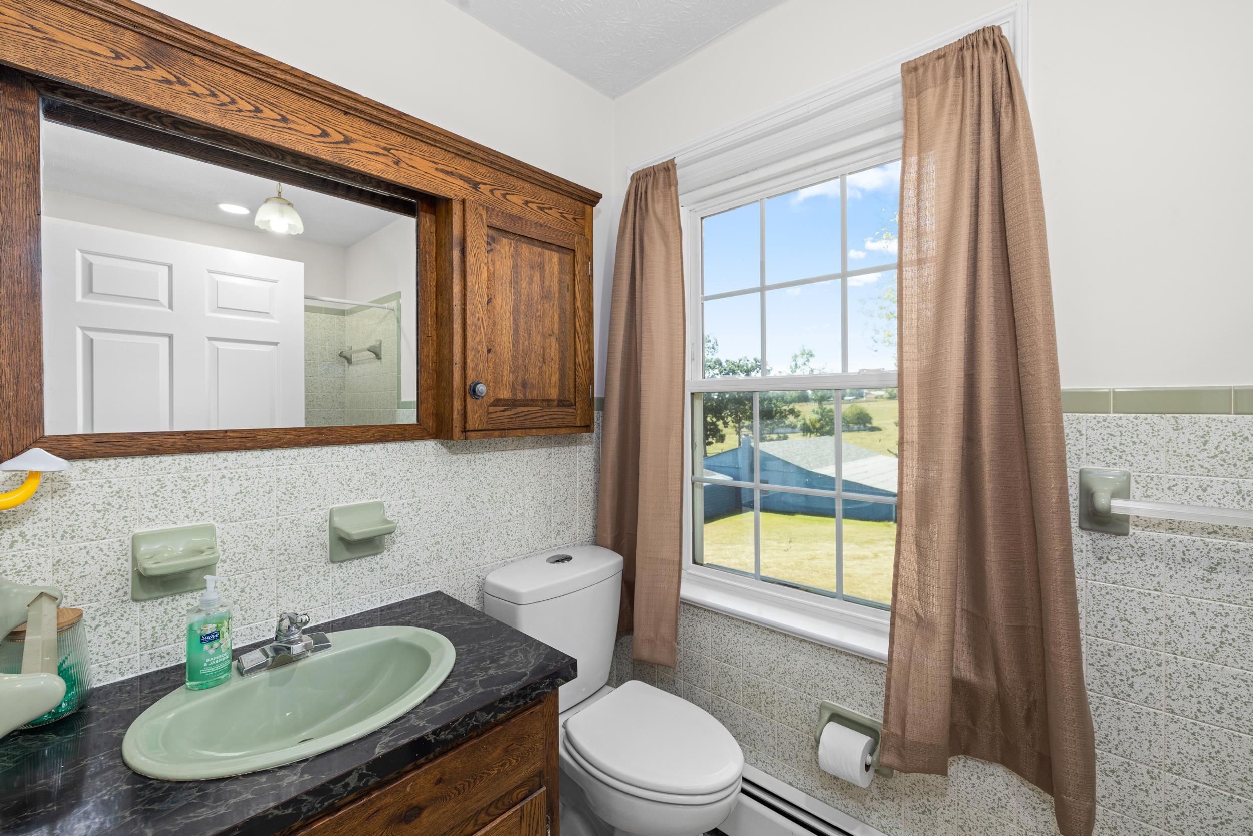 1370 Middlebrook Road Staunton, VA 24401 - Photo 43 of 73 a bathroom with a sink toilet a mirror and tub