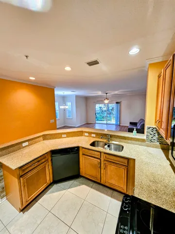 a kitchen with a sink and a stove top oven
